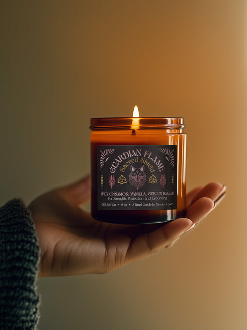 Amber glass jar with Guardian Flame label featuring a metallic wolf and flame motifs in pink and gold. Spicy cinnamon, vanilla, and gurjun balsam candle. 9 oz soy candle by Grimoire & Goblet.